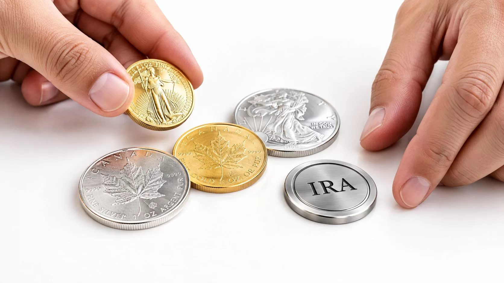 Hands arranging gold and silver coins alongside a circular metallic disc labeled with IRA acronym.